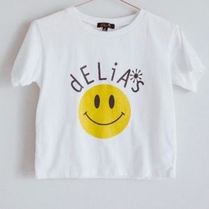 dELiA’s smiley face white graphic crop top with yellow glittery smiley face